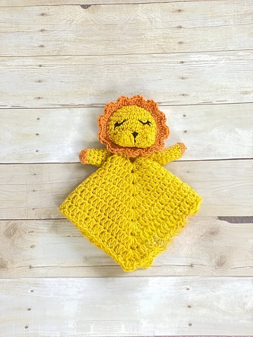 A playful lion lovey puppet